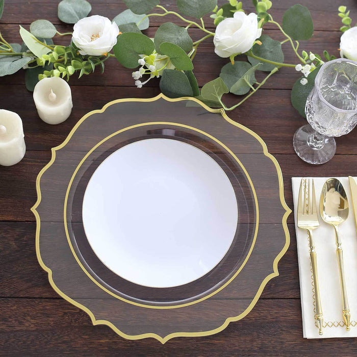 Elegant gold-accented clear charger plate with white inner plate on a rustic table setting.