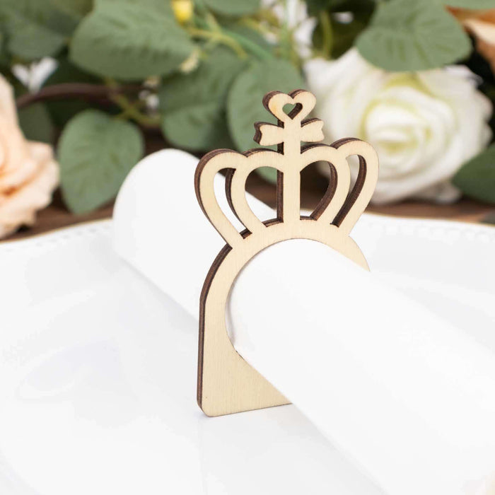 Wooden crown napkin holder on a plate with floral background.
