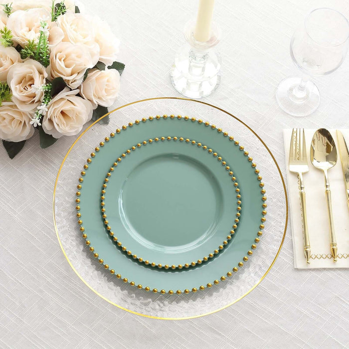 Elegant teal dinner plates with gold beading on a beautifully set table.