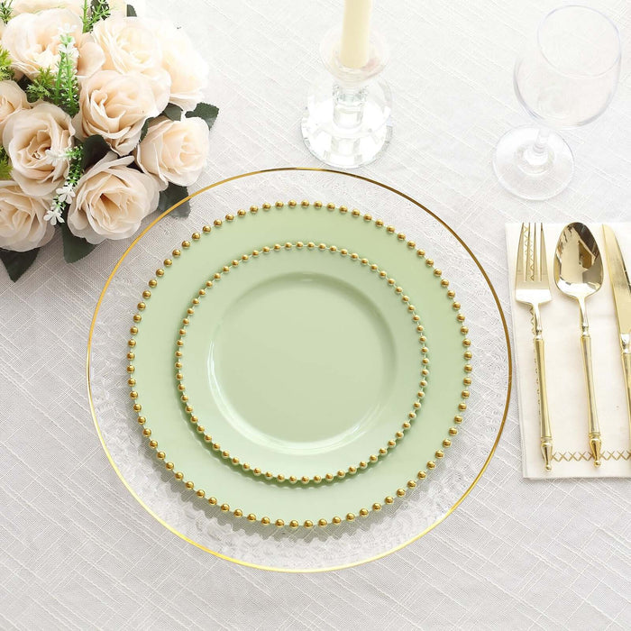 Elegant green dinnerware set with gold accents on a table setting.