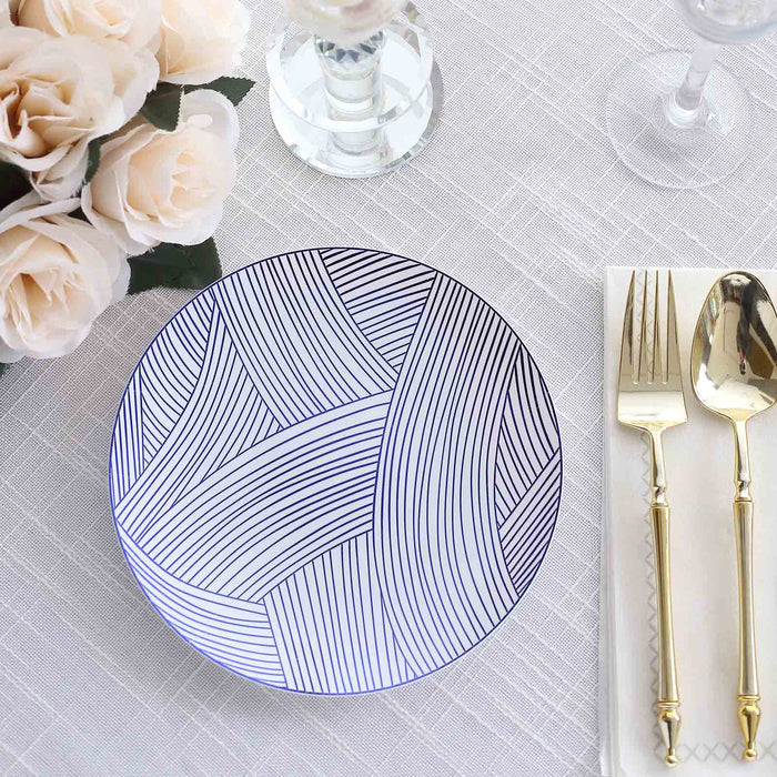 Decorative plate with a modern line design on a dining table setting.