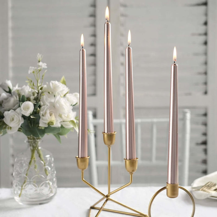 Elegant candle holder with four lit candles and floral arrangement.