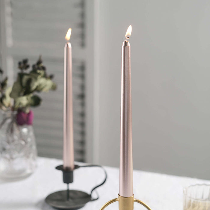 Elegant pink taper candles in stylish holders on a serene table setting.