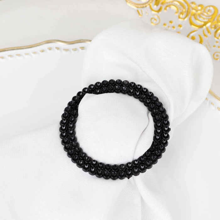Black beaded hair tie on a white napkin.