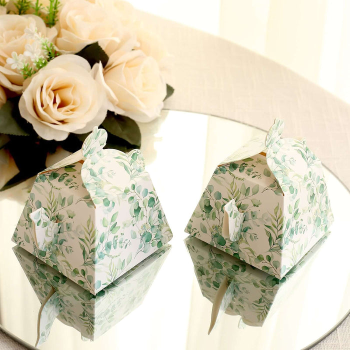 Floral-themed gift boxes on a mirrored surface with roses in the background.