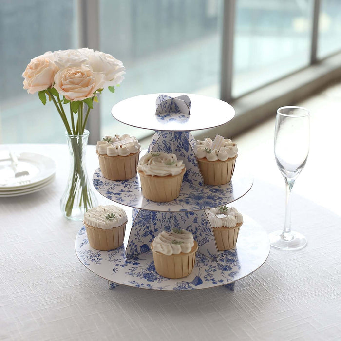 Cupcake stand with decorated cupcakes and flowers in a bright setting.
