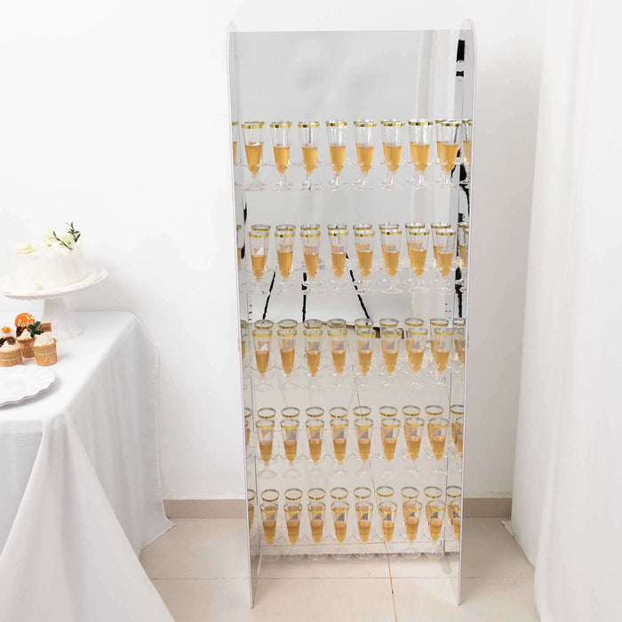 Mirrored champagne tower display with glasses filled with champagne.