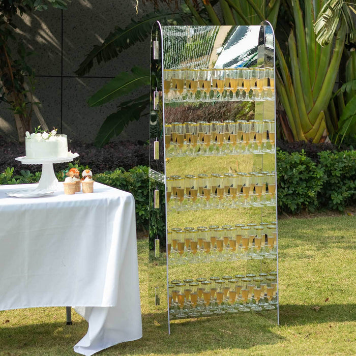 Mirrored champagne tower display at an outdoor event.