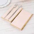 Elegant pink napkins with gold edges, styled with a fork and knife.