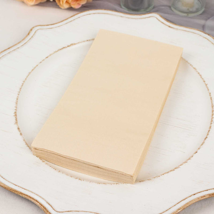 Stack of cream-colored blank paper sheets on a decorative plate.
