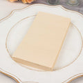 Stack of cream-colored blank paper sheets on a decorative plate.