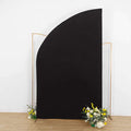 Black curved backdrop with floral arrangement at the base