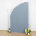 Curved blue backdrop with floral accents in a studio setting.