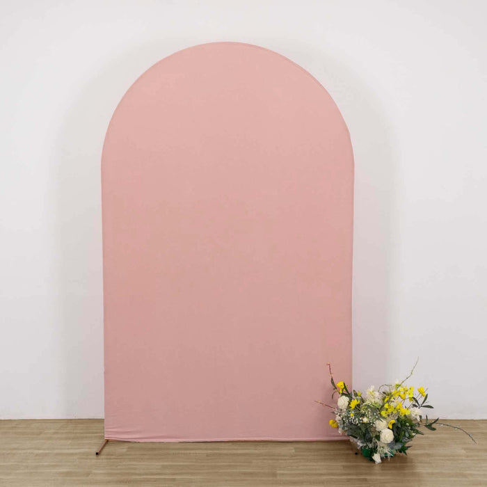 Pink arch backdrop with floral arrangement at the base.