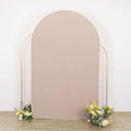 Neutral fabric backdrop with floral arrangements at the base.