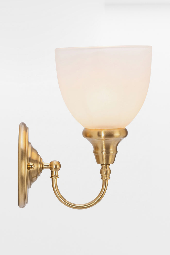Illuminated Satin Brass wall sconce with gooseneck arm and an opal shade.