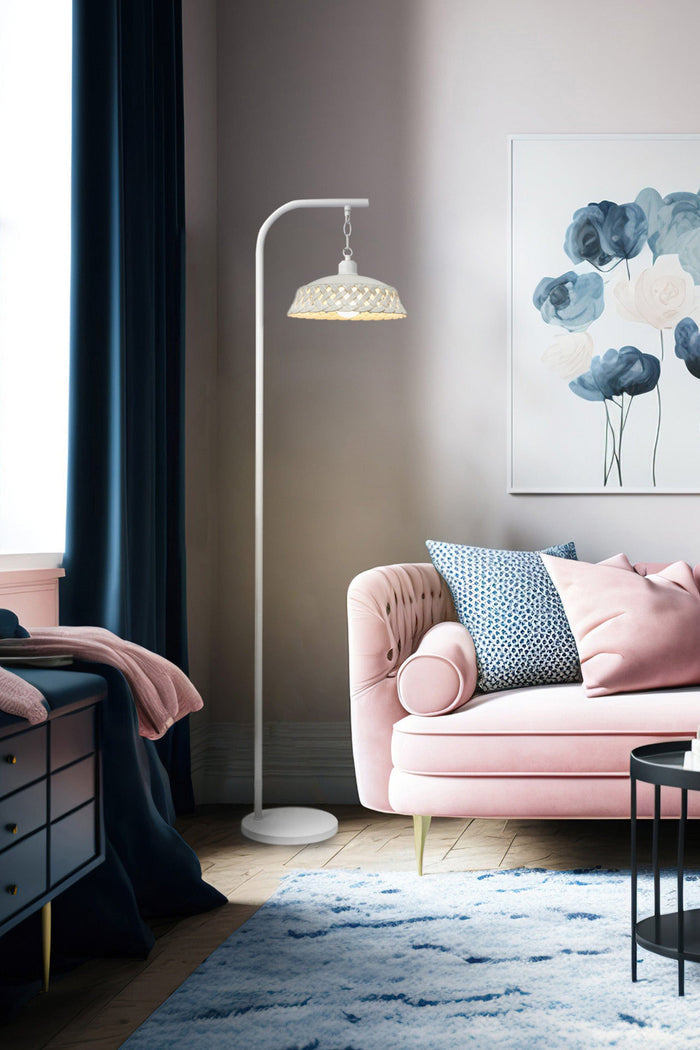 Ceramic floor lamp with white base within a living room setting.