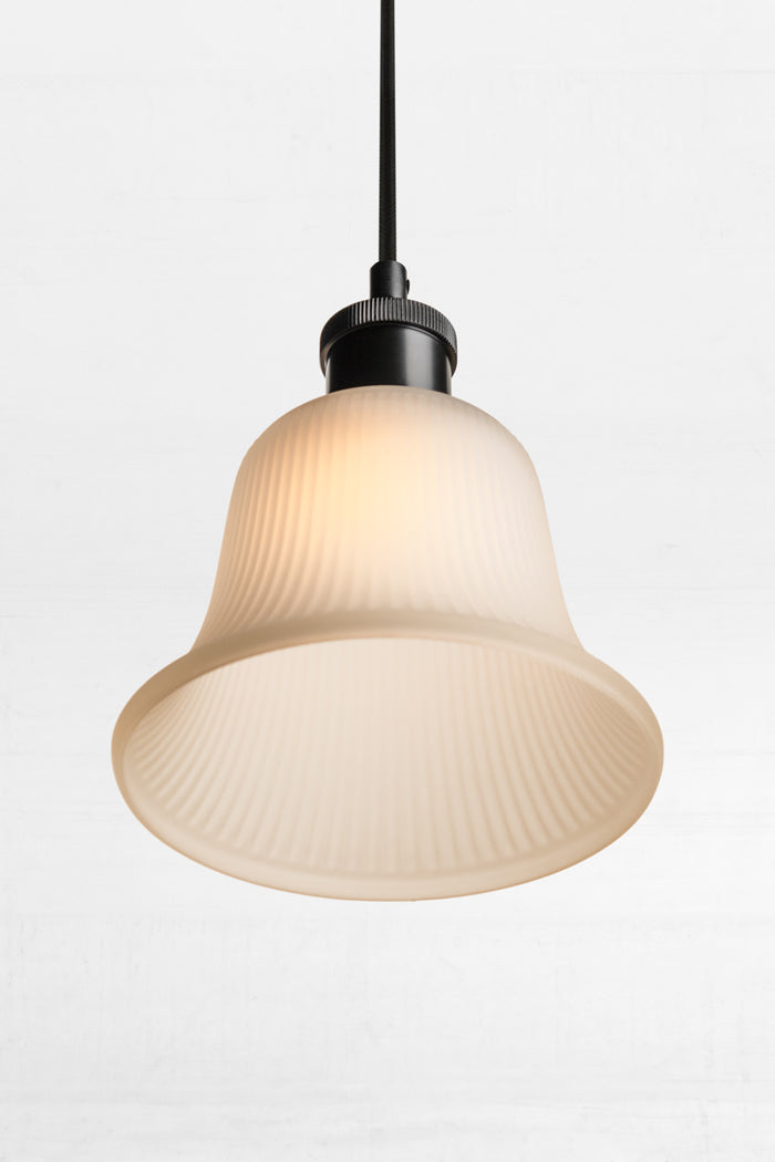 Featuring visible ridges, this bell-shaped frosted glass shade has a textured appearance.