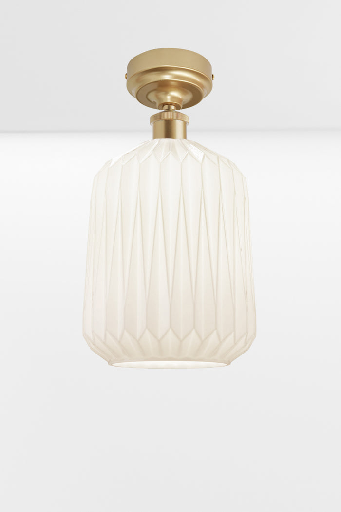 Modern geometric detailed opal glass shade, paired with a gold/brass batten holder.