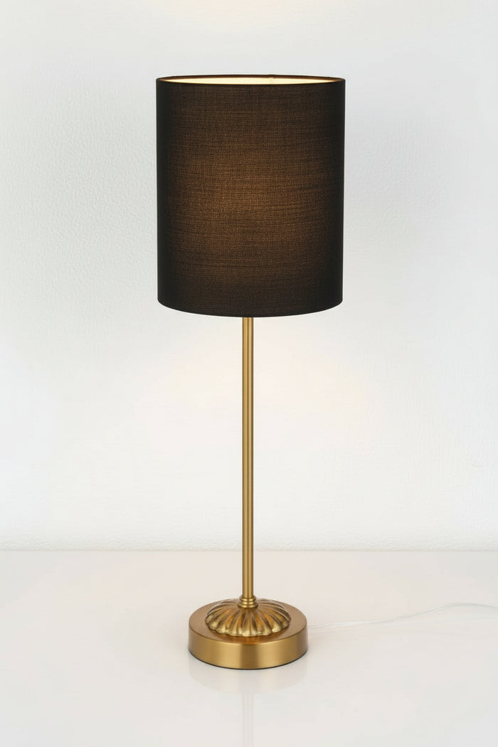 Illuminated antique gold table lamp stand with black fabric shade.