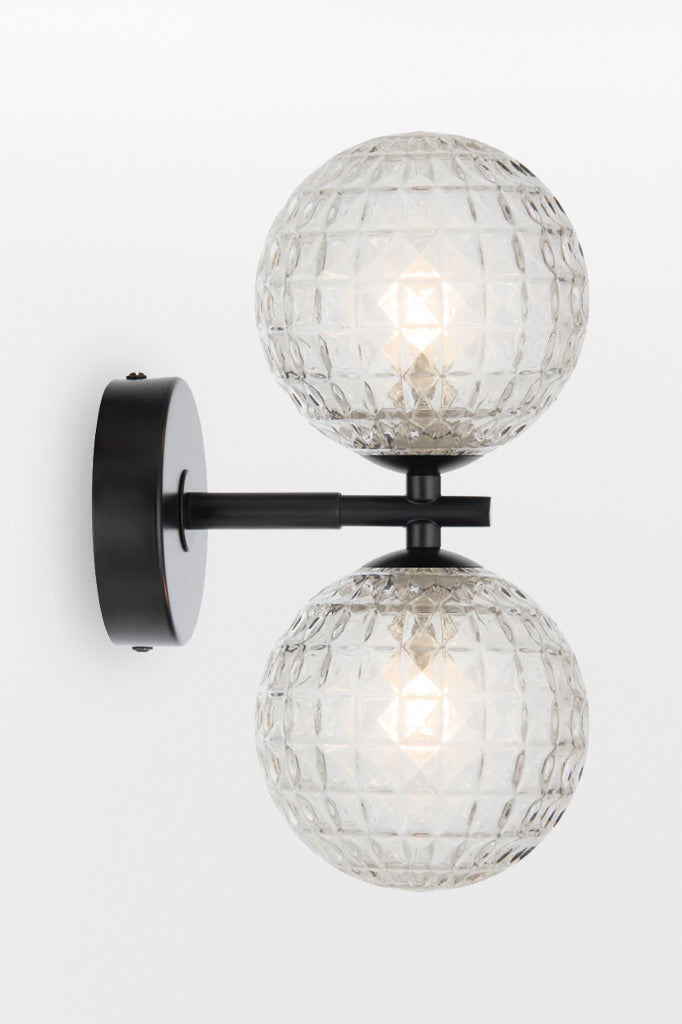 Black double up/down lampholder wall light with clear prism finish.