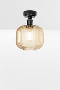 Amber reeded glass shade paired with a black batten holder.