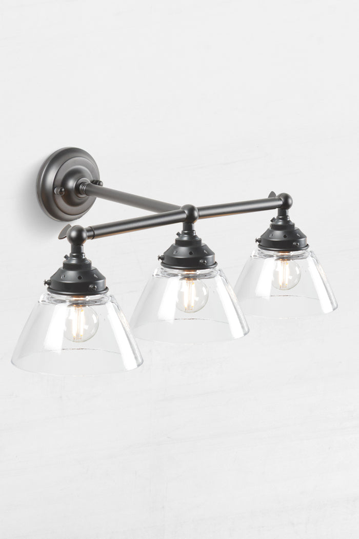 Black triple lamp wall sconce with swivel lampholders for directional lighting