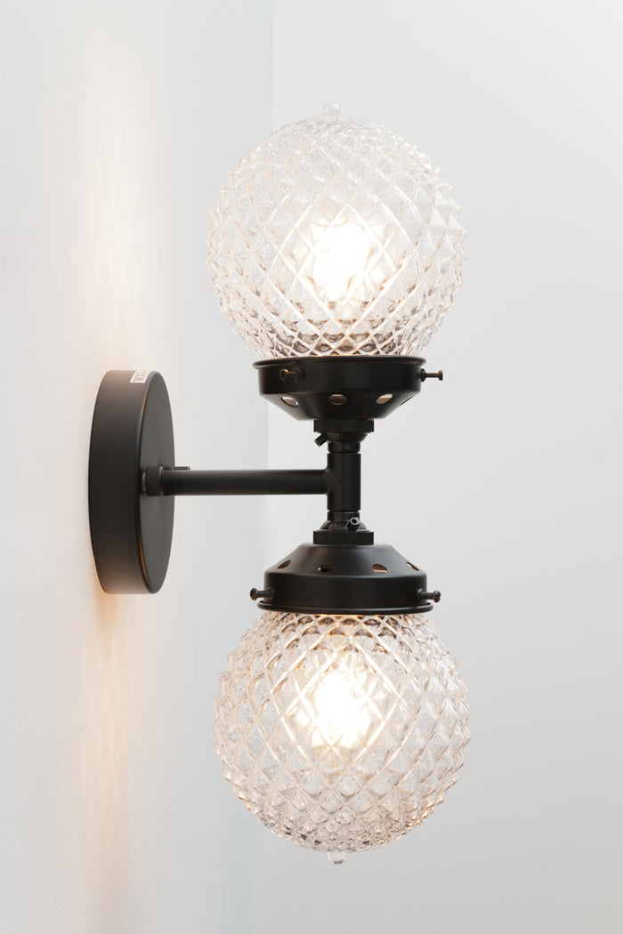 Dual lampholders provide balanced illumination, making it suitable as both a feature light and a practical wall sconce.