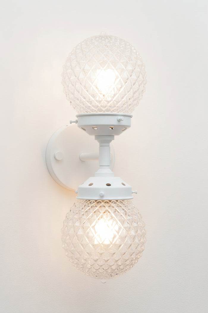 Dual lampholders provide balanced illumination, making it suitable as both a feature light and a practical wall sconce.