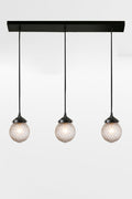 Three light linear with black hardware and vintage insipred textured glass.