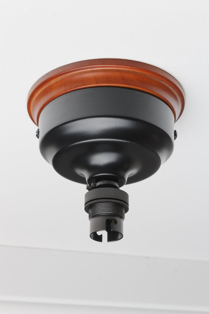black batten holder on a wooden mounting block