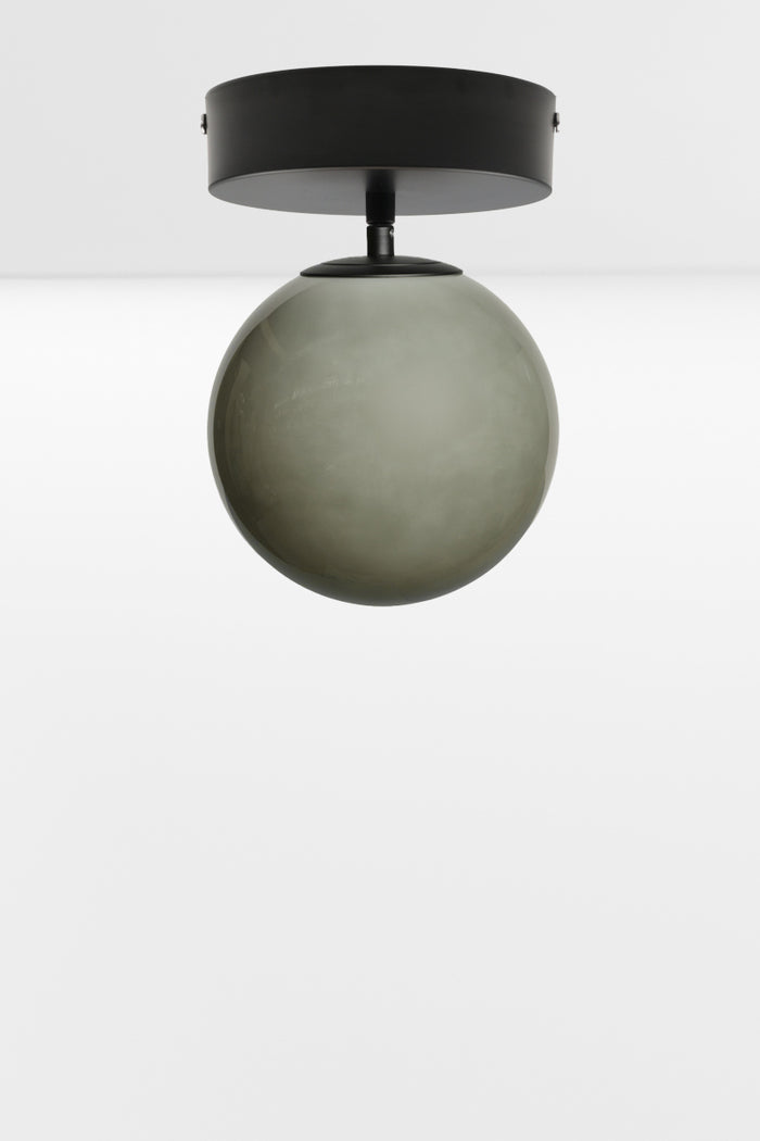 Light grey glass orb shade on a black batten holder.
