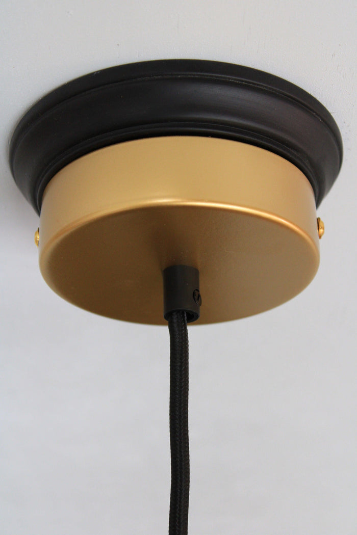 gold ceiling rose on black wooden block