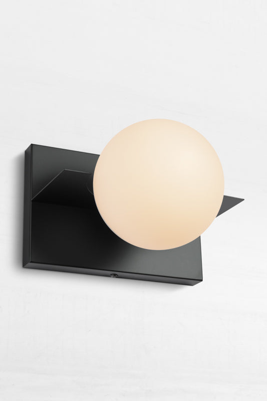 Black sconce with opal glass shade beautiffuly diffeses light