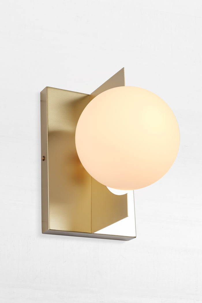 Gold sconce with opal glass shade beautiffuly diffeses light