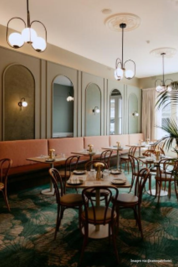 Dining room of the @ramsgatehotel with three black looped chandeliers with 3 opal glass ball shades.