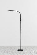 Floor Lamp in black finish against white wall and terrazzo floor