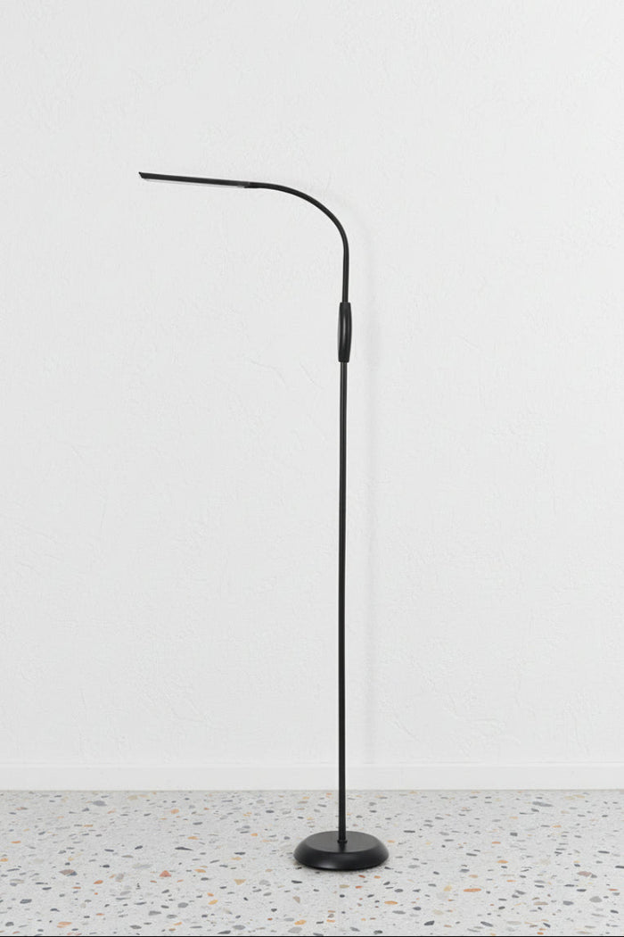 Floor Lamp in black finish against white wall and terrazzo floor
