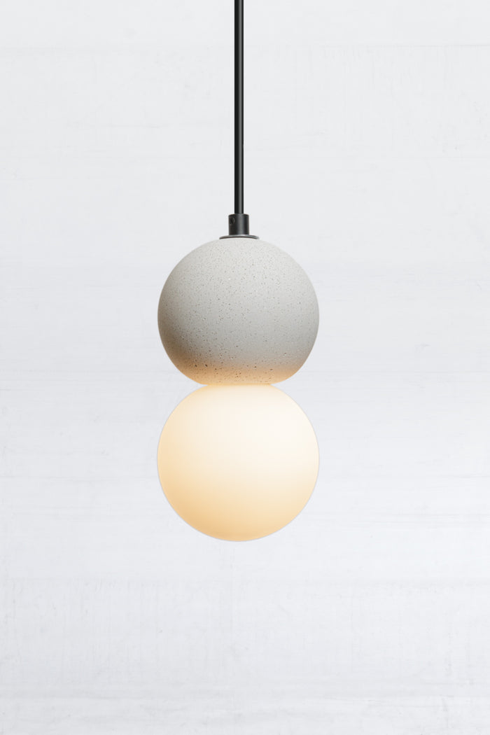 Front view of the glass and concrete orb pendant light on black cord