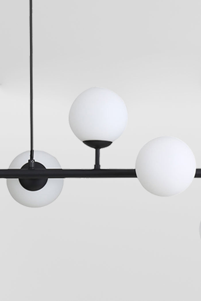 Close up of the black 6 light linear glass ball pendant light.
