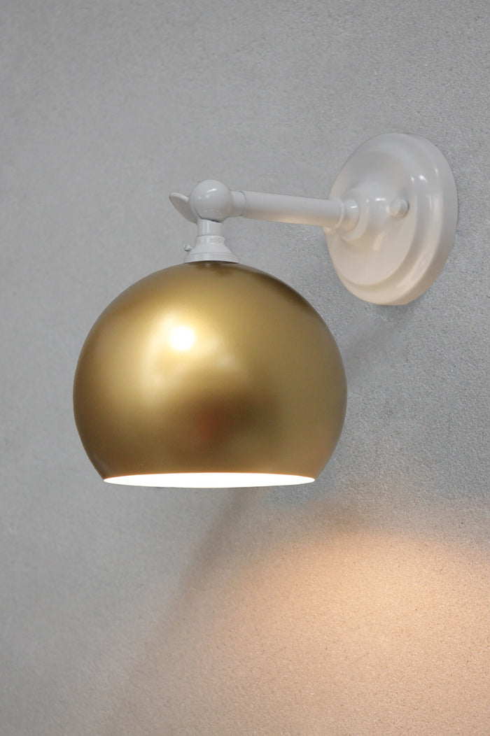 White short, straight wall sconce with a gold bowl shade.