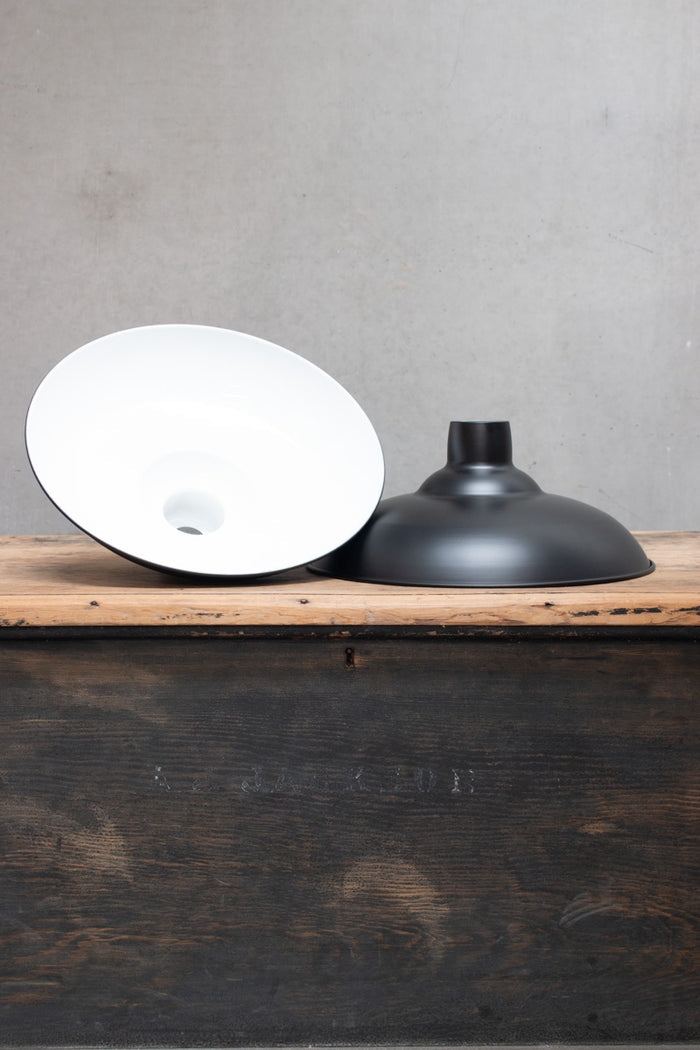 Metal shade in black with white inner.