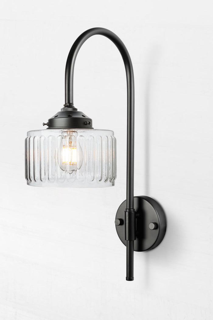 Black shepherds hook wall light paired with a clear glass shade.