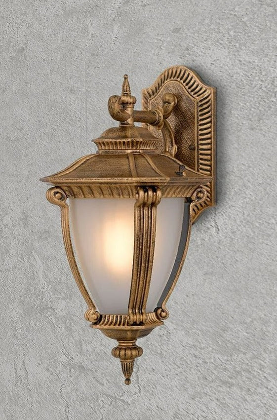 Outdoor wall light in antique gold finish.