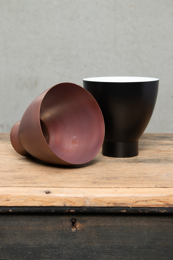 Copper and black celler shades side by side.