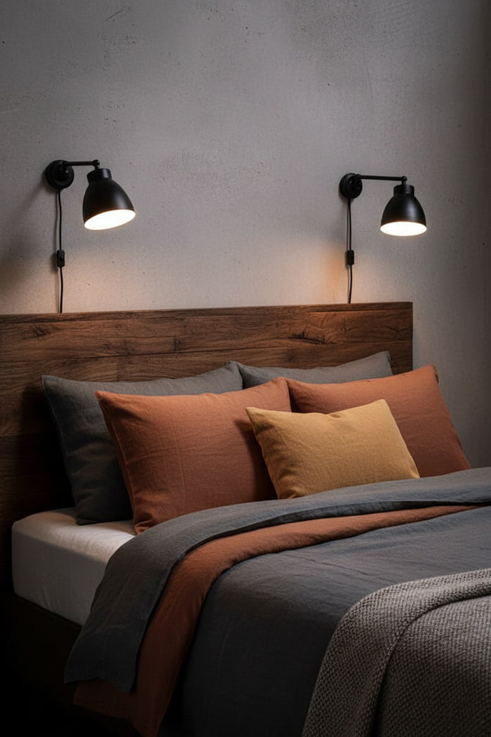 Bedroom with wooden headboard, brown bedding, and DIY wall-mounted lamps with wall plug