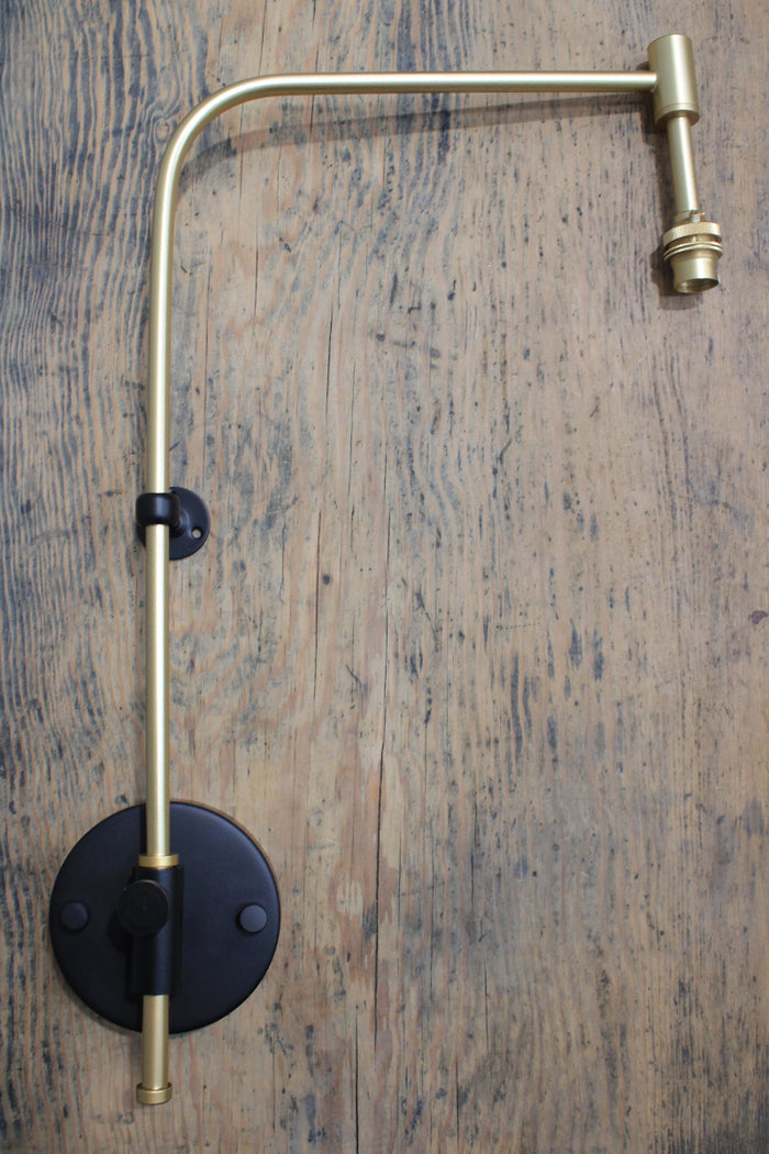 Gold/brass wing arm wall fixture.
