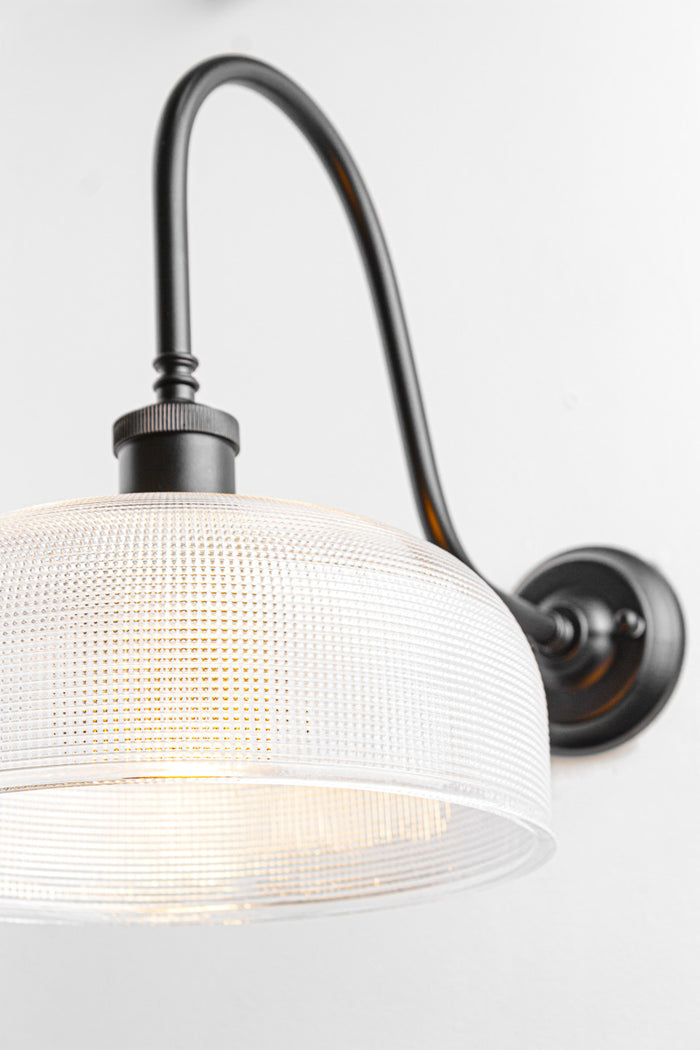 Close up of the Large clear holophane shade on a black extra large gooseneck outdoor wall sconce.