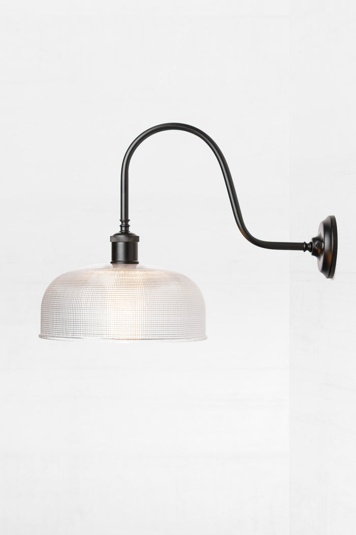 Side view of the Large clear holophane shade on a black extra large gooseneck outdoor wall sconce.