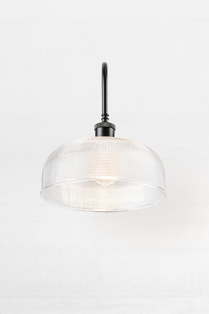 Front view of the Large clear holophane shade on a black extra large gooseneck outdoor wall sconce.